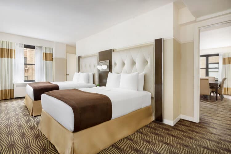 double room with double twin beds large windows and view of nyc
