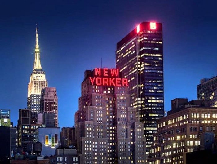 the new yorker at night with red light singage