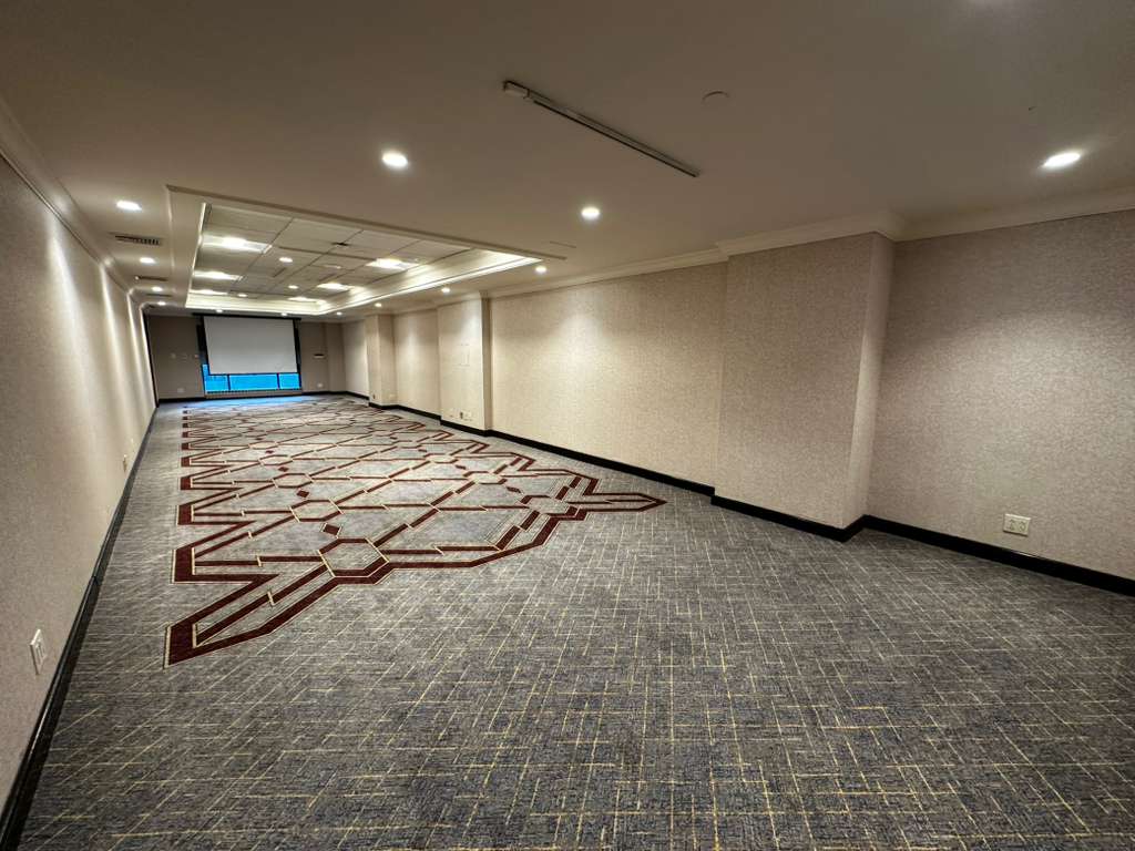 kips bay suite with all chairs removed to show open plan of long room for guest meetings and events