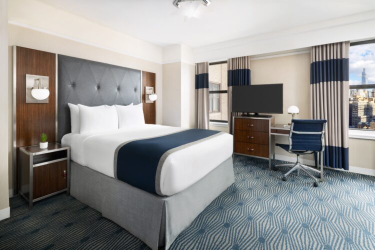 exec queen suite at the new yorker midtown nyc with two double windows, television set and two nightstands