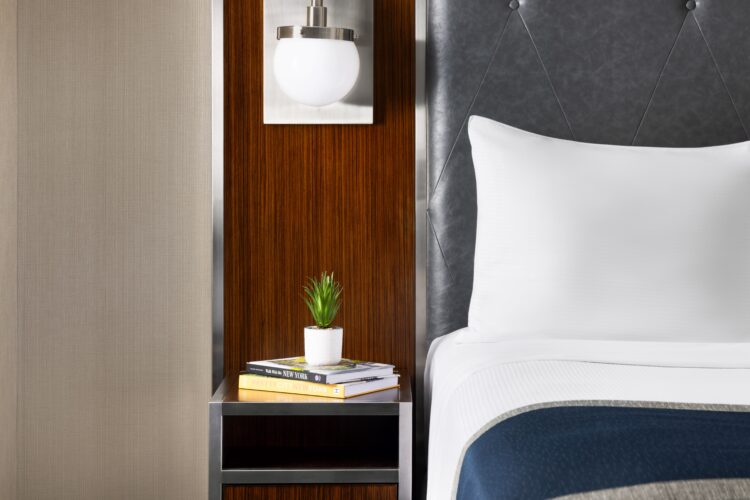 exec queen suite and nightstand at the new yorker midtown nyc with decorative plant pots and lighting