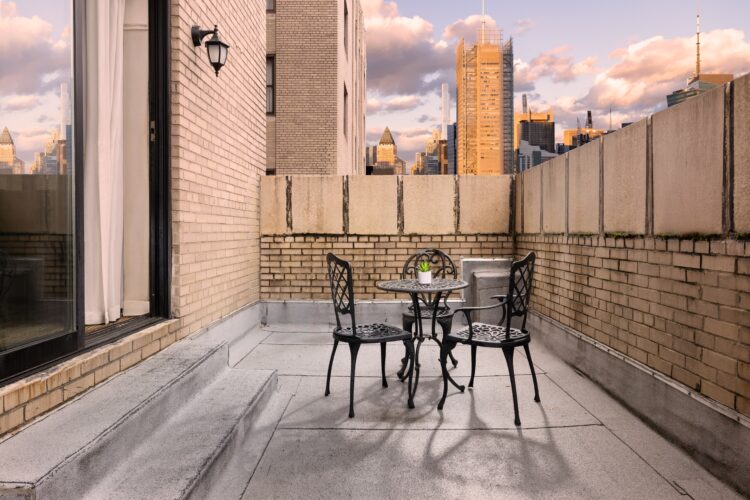 Spacious outdoor terrace with seating area and skyline views