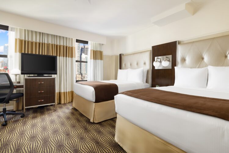 hotel queen suite at the new yorker twin bed view and view of new york through window with television set