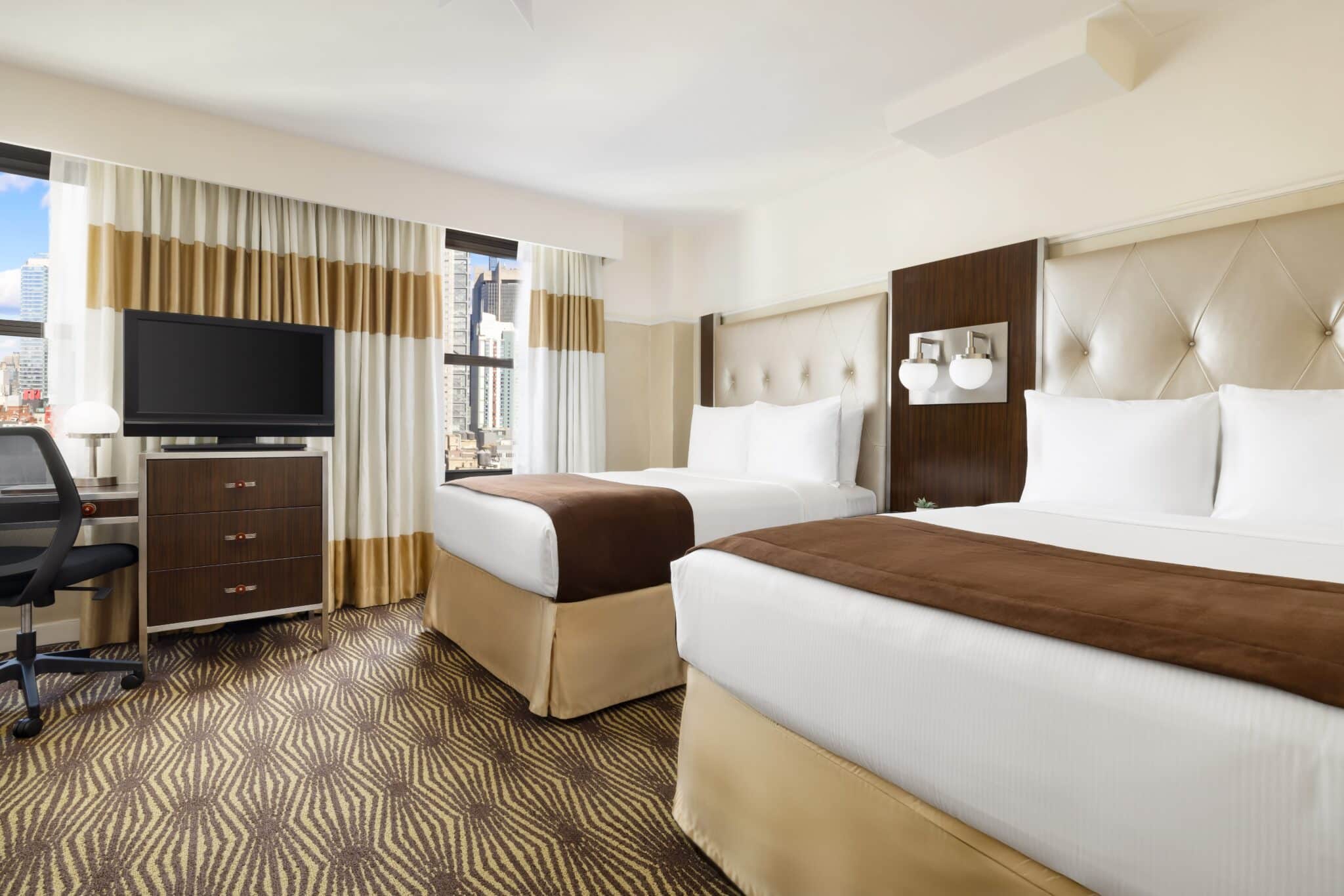 hotel queen suite at the new yorker twin bed view and view of new york through window with television set