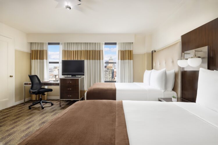 hotel queen suite at the new yorker twin bed side view of manhattan