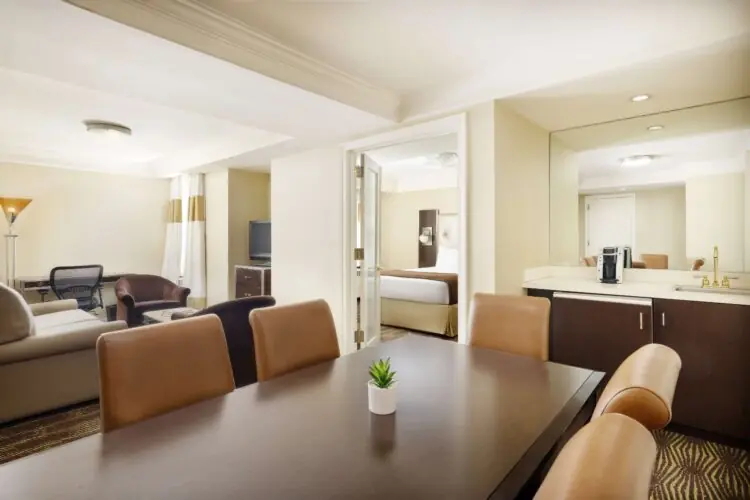 queen suite from dining table with coffee machine and television view