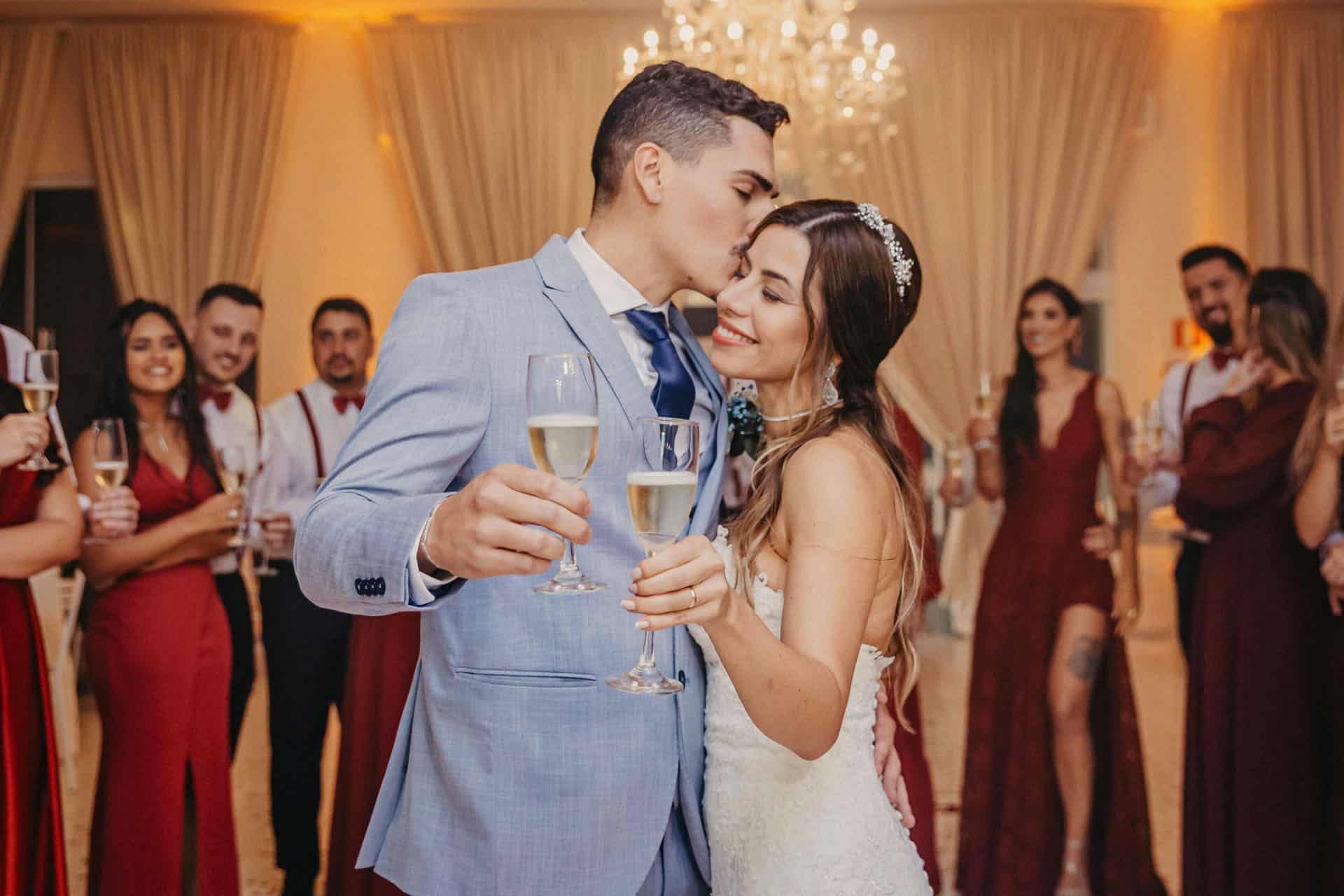husband and wife cheering with glass of champagne at wedding