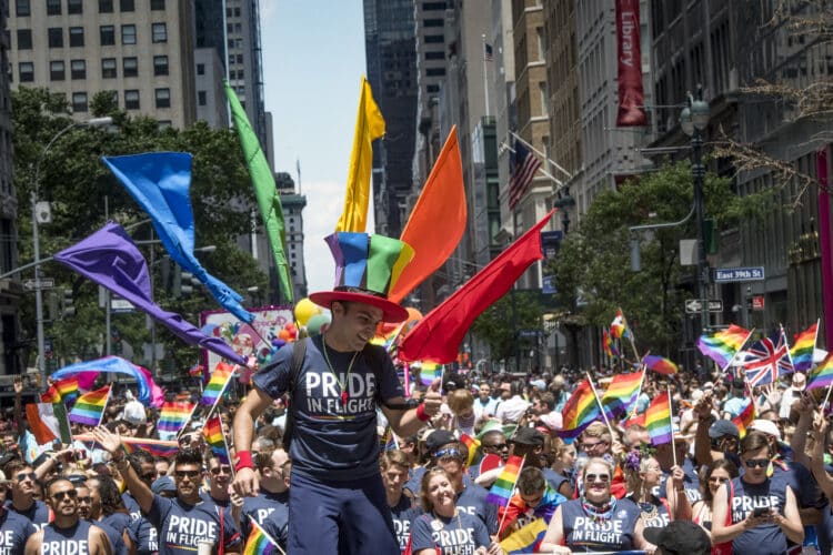 pride in flight with people marching new york with colourful rainbow flags