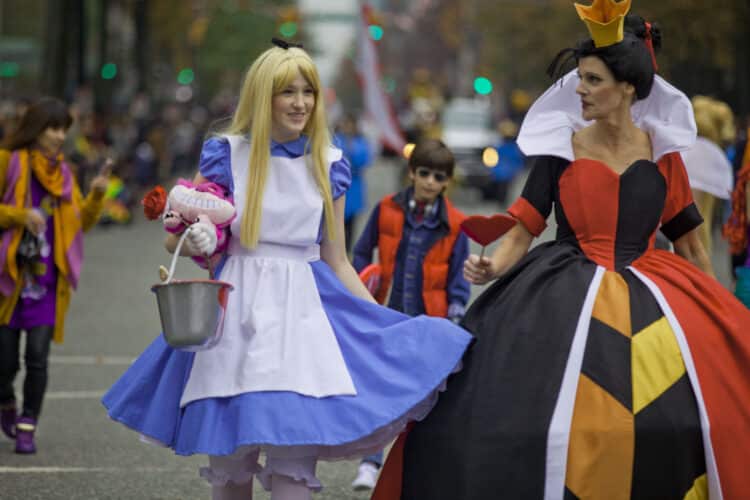 Halloween parade two women dressed as alice and queen of hearts