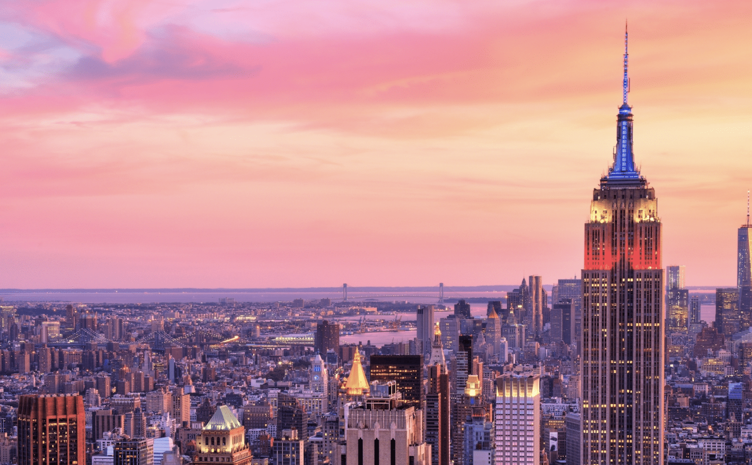 empire state building at dusk over new york skyline