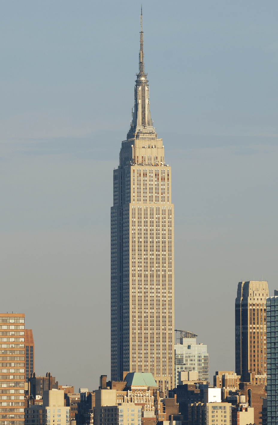 portrait view of the empire state building on a clear sunny day